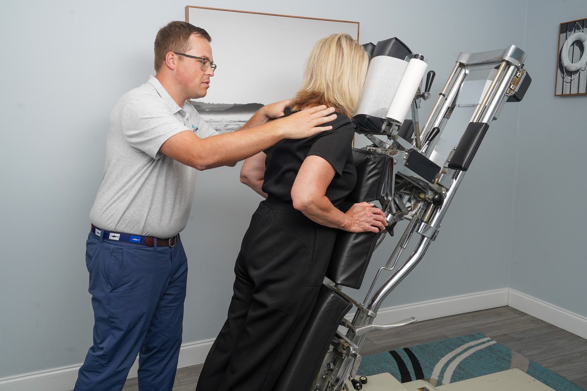 doctor with patient and exercise equipment