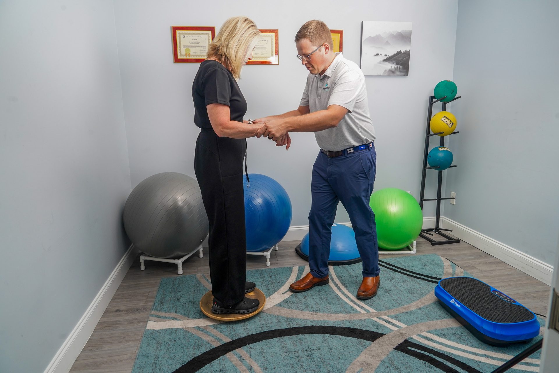 doctor with patient and exercise equipment